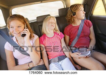 Siblings in the back seat of a car View Large Photo Image Stock Image - Siblings in the back seat of a car. Fotosearch