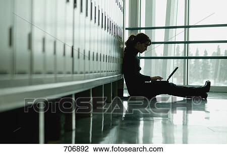 Student sitting by lockers View Large Photo Image Stock Image - Student sitting by lockers. Fotosearch