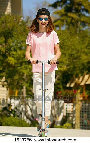 Teenager on a scooter View Large Photo Image Stock Photograph - Teenager on a scooter. Fotosearch