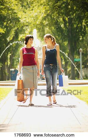 Stock Image - Teens with shopping bags. Fotosearch