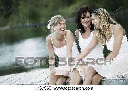 Three women enjoy a laugh View Large Photo Image Stock Image - Three women enjoy a laugh. Fotosearch