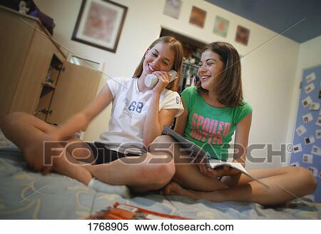Stock Photography - Two girls on the phone. Fotosearch