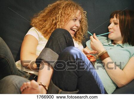Two girls share a laugh View Large Photo Image Stock Image - Two girls share a laugh. Fotosearch