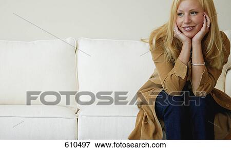 Woman smiles on sofa View Large Photo Image Stock Photo - Woman smiles on sofa. Fotosearch