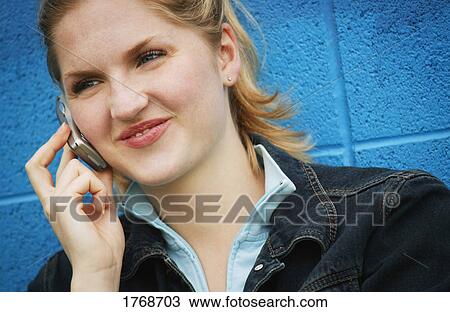 Woman talks on cell phone View Large Photo Image Stock Image - Woman talks on cell phone. Fotosearch