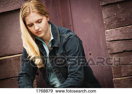 Young woman wearing a thoughtful expression View Large Photo Image Stock Photo - Young woman wearing a thoughtful expression. Fotosearch