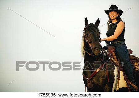 A cowgirl on a horse View Large Photo Image Stock Photography - A cowgirl on a horse. Fotosearch
