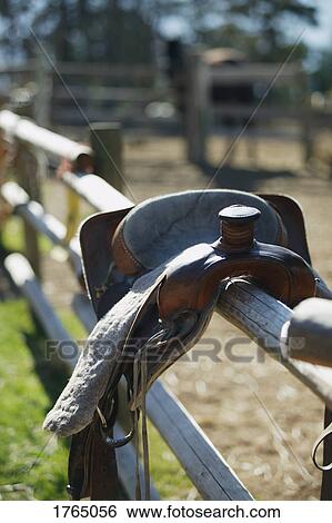A saddle on a fence View Large Photo Image Stock Photograph - A saddle on a fence. Fotosearch