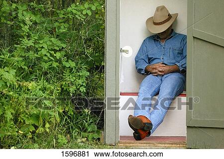 Cowboy in the outhouse View Large Photo Image Stock Image - Cowboy in the outhouse. Fotosearch