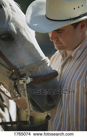 Picture - Cowboy with his horse. Fotosearch