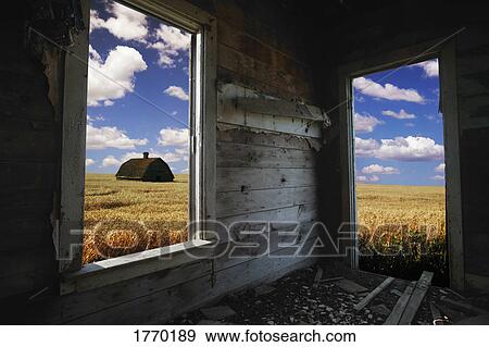 Stock Photo - Looking out farm building to field. Fotosearch