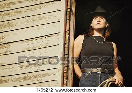 Stock Image - Portrait of a cowgirl. Fotosearch