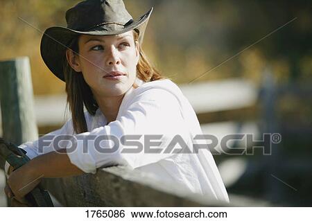 Stock Photograph - Portrait of a cowgirl. Fotosearch