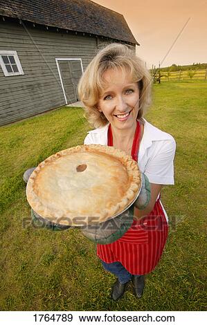 Woman holds a fresh pie View Large Photo Image Stock Photo - Woman holds a fresh pie. Fotosearch