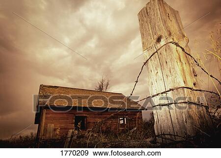 Stock Photo - Wood shack and barbed wire. Fotosearch