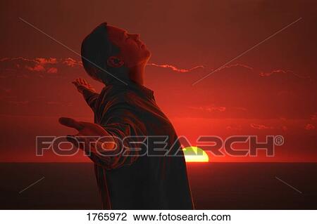 Stock Image - A man meditating. Fotosearch
