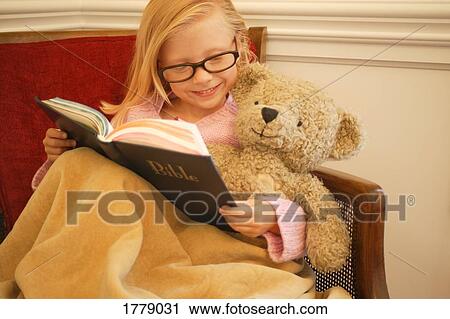 Child reads her Bible to her teddy bear View Large Photo Image Stock Image - Child reads her Bible to her teddy bear. Fotosearch