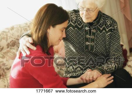 Stock Photo - Senior and Woman praying. Fotosearch