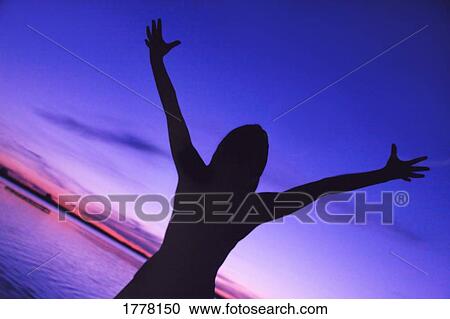 Silhouette of woman with arms raised View Large Photo Image Stock Image - Silhouette of woman with arms raised. Fotosearch