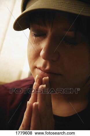 Stock Photo - Teenager prays. Fotosearch