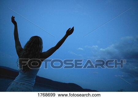 Woman lifts her hands toward heaven View Large Photo Image Stock Photo - Woman lifts her hands toward heaven. Fotosearch