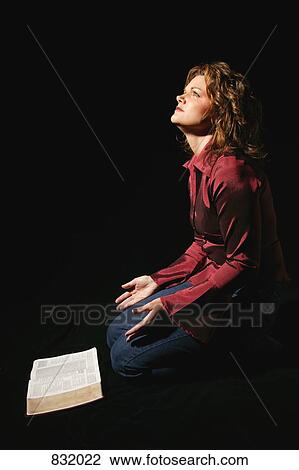 Woman praying in front of Bible View Large Photo Image Stock Image - Woman praying in front of Bible. Fotosearch