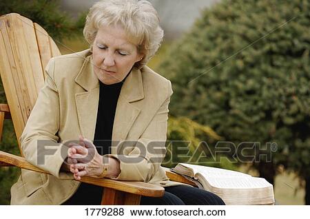 Stock Photo - Woman prays. Fotosearch