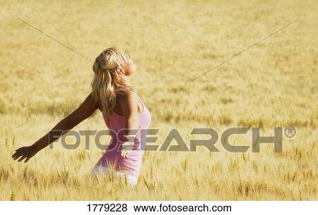 Stock Photo - Woman turns her face upwards. Fotosearch