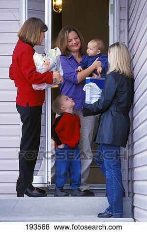 Stock Photo - Women talking to mother at front door. Fotosearch