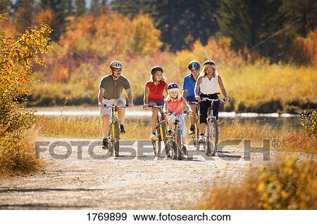 A family goes cycling together View Large Photo Image Stock Photo - A family goes cycling together. Fotosearch
