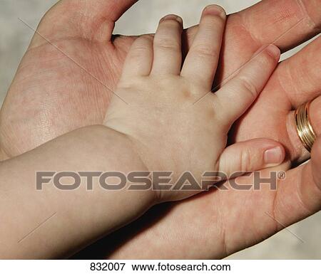 Baby's and Father's hands View Large Photo Image Stock Photo - Baby's and Father's hands. Fotosearch