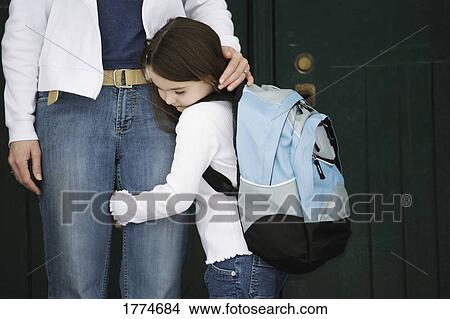 Picture - Child holding mother's leg. Fotosearch