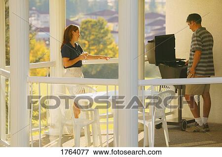 Couple enjoy a barbecue View Large Photo Image Stock Photo - Couple enjoy a barbecue. Fotosearch
