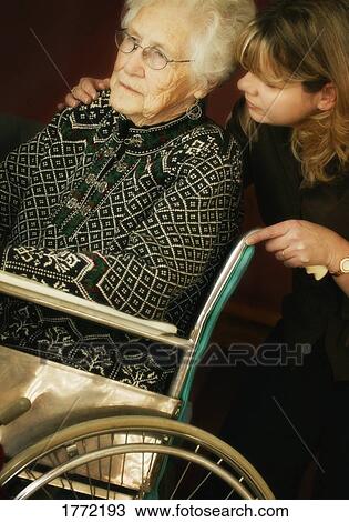 Stock Image - Elderly lady being comforted. Fotosearch