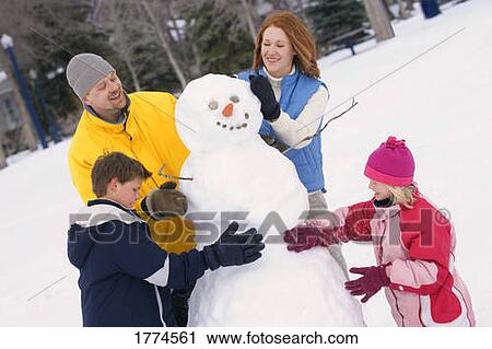 Family building snowman View Large Photo Image Stock Image - Family building snowman. Fotosearch