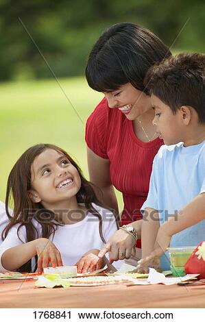 Stock Image - Family works on finger painting. Fotosearch