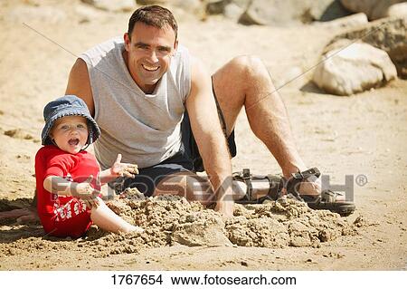 Father and daughter play in sand View Large Photo Image Picture - Father and daughter play in sand. Fotosearch