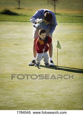 Father and son practice golf View Large Photo Image Stock Photography - Father and son practice golf. Fotosearch
