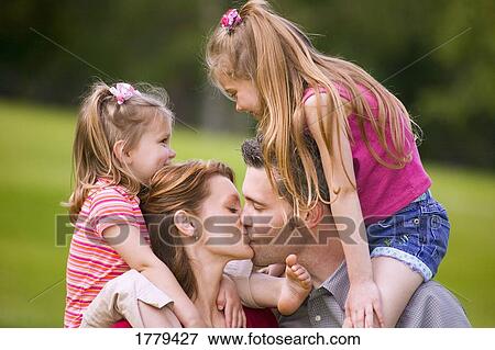 Girls watch parents kiss View Large Photo Image Stock Photo - Girls watch parents kiss. Fotosearch