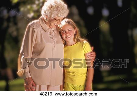 Stock Photo - Grandmother hugging granddaughter. Fotosearch