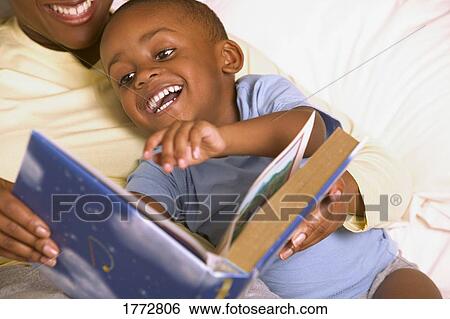 Stock Photograph - Mother reading bedtime story. Fotosearch