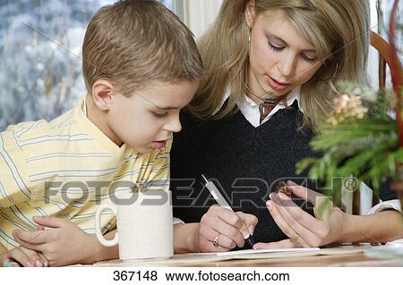 Stock Photo - Mother son working at table. Fotosearch