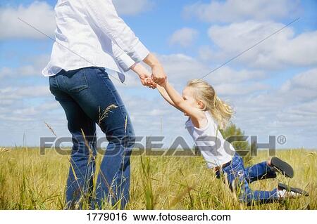 Stock Photograph - Mother swings child. Fotosearch