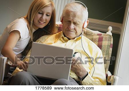 Teen shows senior how to use computer View Large Photo Image Stock Photo - Teen shows senior how to use computer. Fotosearch