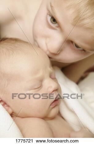 Young boy kissing baby View Large Photo Image Stock Image - Young boy kissing baby. Fotosearch