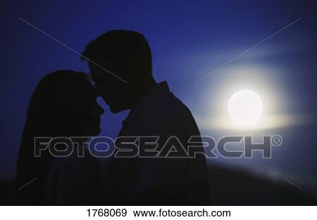 A Kiss By Moonlight Stock Photo Fotosearch