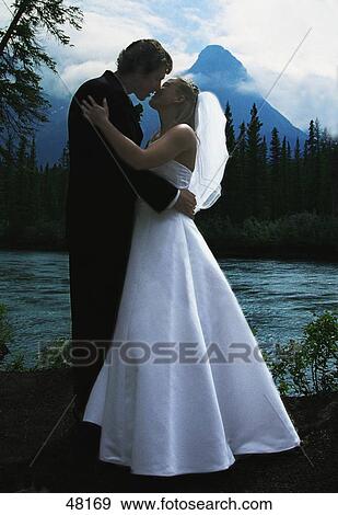 Stock Photo - Bride and groom kissing. Fotosearch