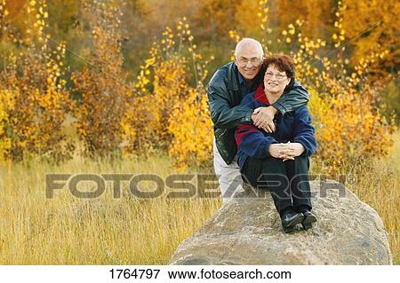 Couple in a field View Large Photo Image Stock Photo - Couple in a field. Fotosearch