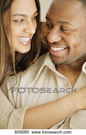 Stock Image - Couple smiles at each other. Fotosearch