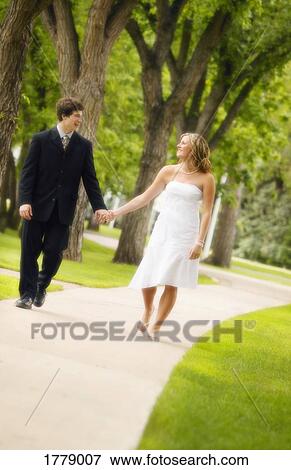 Stock Photo - Couple walk hand in hand. Fotosearch